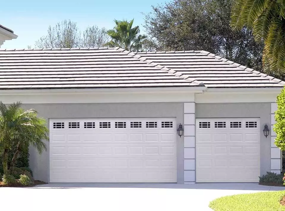 Elegant modern garage doors enhance the curb appeal of a suburban home in a sunny neighborhood