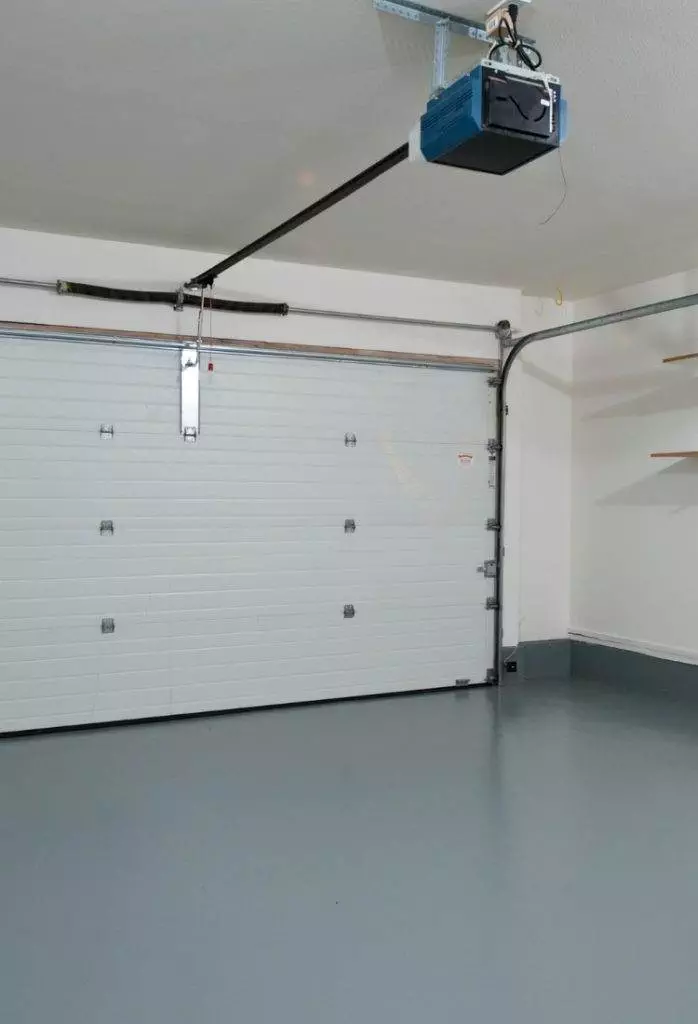 Spacious garage interior with a clean floor and automatic door opener in a modern home