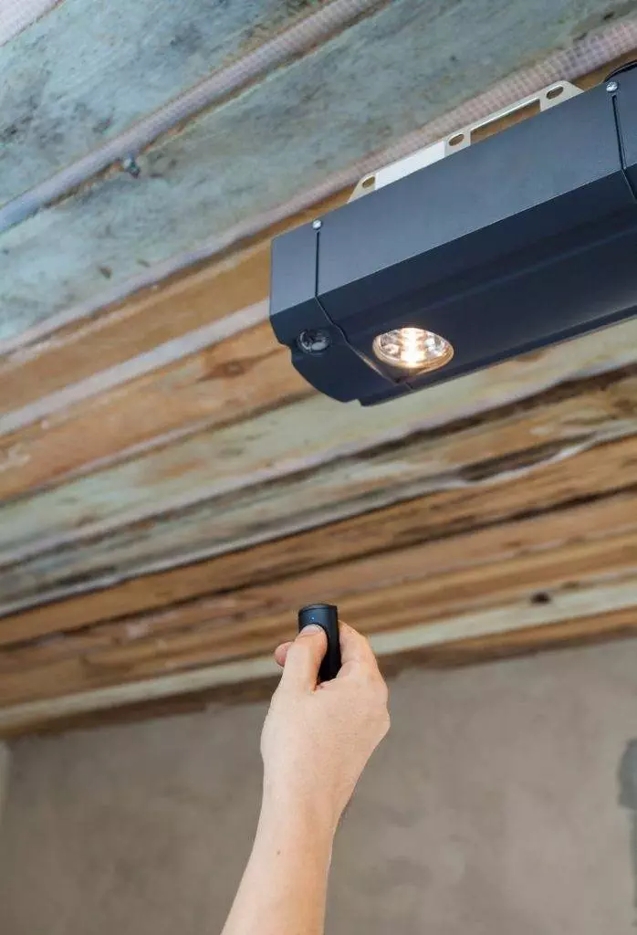 Hand holding a flashlight to check the ceiling lights in a home renovation project