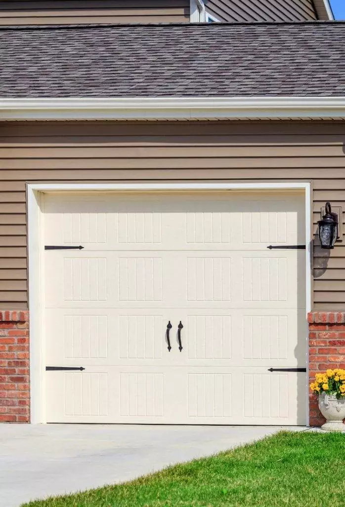 Beautiful garage door with elegant handles and classic design in a residential home located in a suburban area