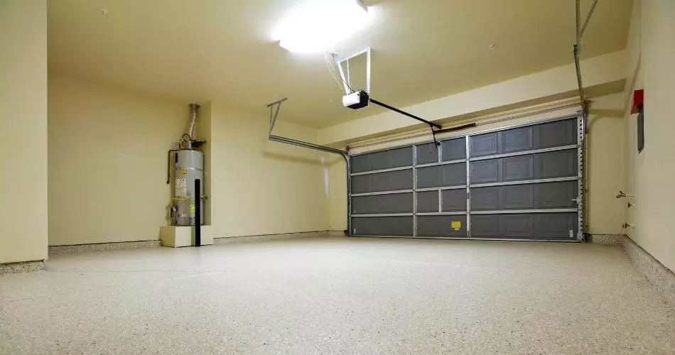 Spacious and clean garage area with gray door and polished floor in a residential property