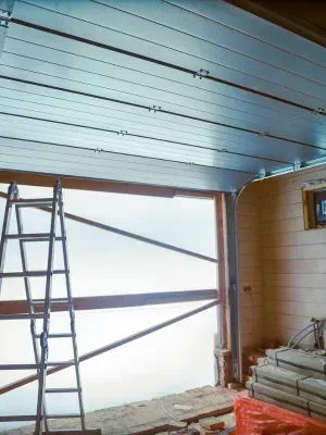 Steel garage door installation in progress at a residential property in Edmonton Steel garage door installation in progress at a residential property in Edmonton