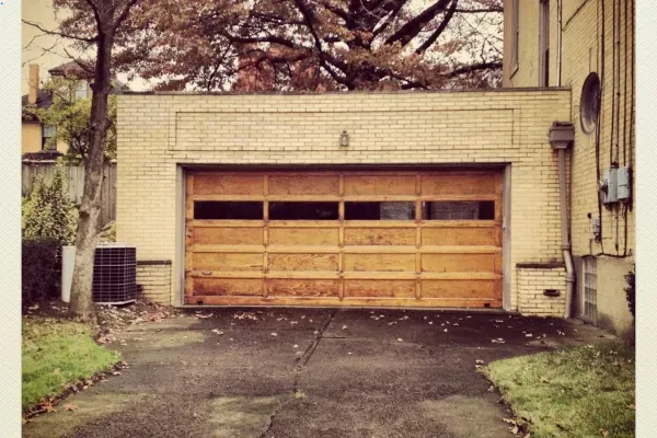 Durable wooden garage doors enhance the exterior appeal of homes in Edmonton during the fall season Durable wooden garage doors enhance the exterior appeal of homes in Edmonton during the fall season