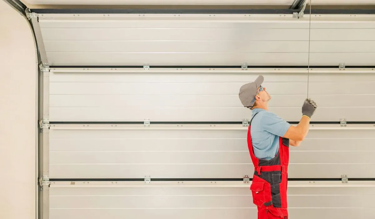 Garage door torsion spring repair for banging noise