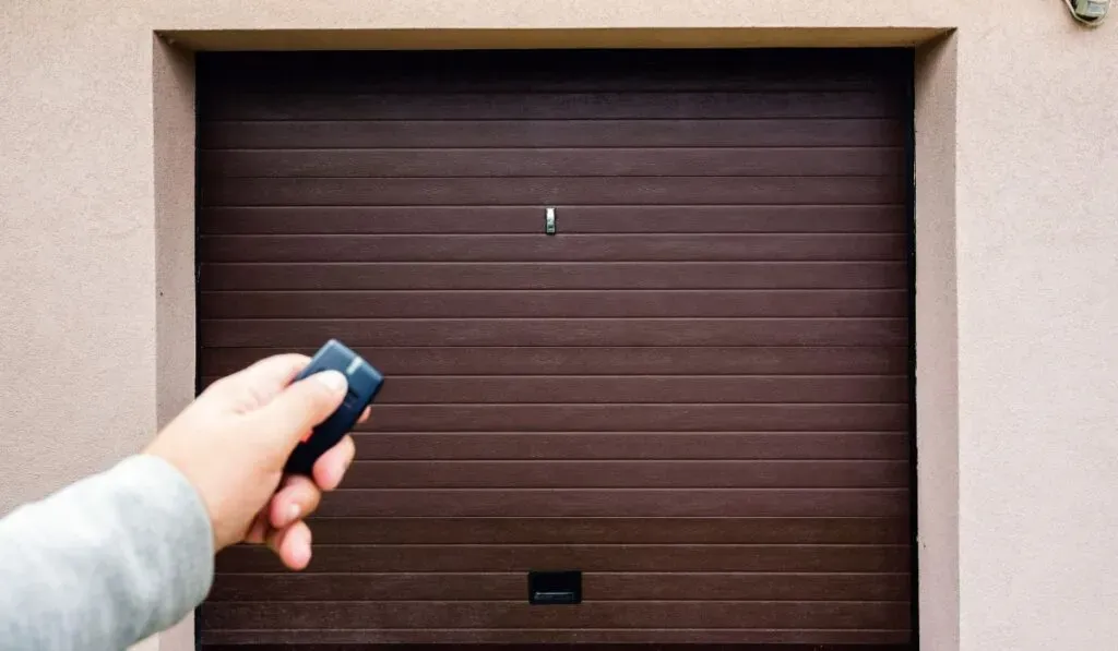 Garage door technician repairing opener receiver