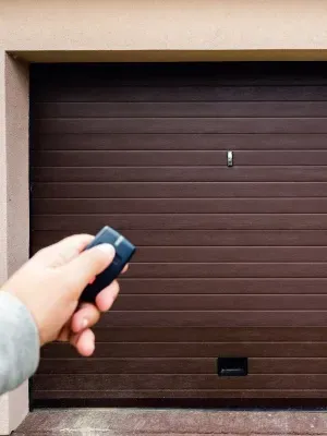Using a garage door opener to access a home with a brown garage door Using a garage door opener to access a home with a brown garage door