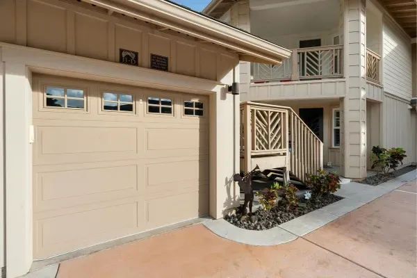 Garage door spring replacement process with tools and repair area in a residential setting Garage door spring replacement process with tools and repair area in a residential setting